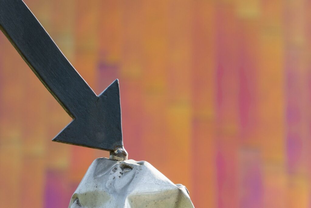 a close up of a metal object with an arrow on it