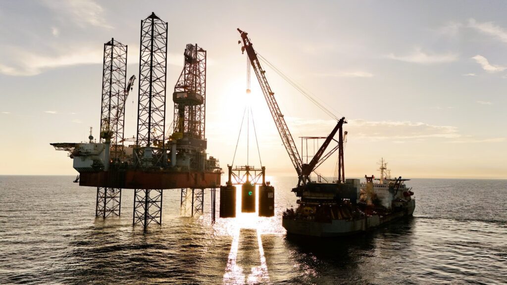 An oil rig being serviced by a supply ship. Petrodollar